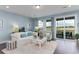 Cozy living room with comfortable seating, decorative pillows, and sliding glass doors to the backyard at 153 Stride Ct., Myrtle Beach, SC 29588
