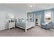 Inviting main bedroom featuring a four-poster bed, blue accents, a cozy chair, and plenty of natural light at 153 Stride Ct., Myrtle Beach, SC 29588