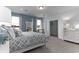 Spacious main bedroom with blue accents, features a four-poster bed, large mirror and closet at 153 Stride Ct., Myrtle Beach, SC 29588