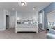 Bright main bedroom boasts a luxurious four-poster bed, soft carpet, and serene blue decor at 153 Stride Ct., Myrtle Beach, SC 29588
