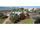 Aerial view of a pool with lounge chairs and waterway views on a sunny day at 1582 South Waccamaw Dr. # 56, Garden City Beach, SC 29576