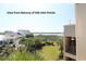 Balcony view overlooking lush greenery and glimpses of the ocean at 1582 South Waccamaw Dr. # 56, Garden City Beach, SC 29576