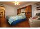 Inviting bedroom with wood floors and a bed with coral-patterned bedding and a matching chair at 1582 South Waccamaw Dr. # 56, Garden City Beach, SC 29576