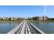 Exterior view of building with unit #56, showcasing waterfront access with lush vegetation and a wooden walkway at 1582 South Waccamaw Dr. # 56, Garden City Beach, SC 29576