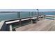 Waterfront view from the wooden dock overlooking the calm water with a white dock and clear blue sky at 1582 South Waccamaw Dr. # 56, Garden City Beach, SC 29576