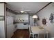 Cozy kitchen with white cabinets, wood flooring and nautical themed accents at 1582 South Waccamaw Dr. # 56, Garden City Beach, SC 29576