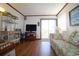 Cozy living room with hardwood floors, slider to a balcony, and comfortable furnishings at 1582 South Waccamaw Dr. # 56, Garden City Beach, SC 29576