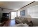 Comfortable living room with view of slider to balcony, natural light and cozy seating at 1582 South Waccamaw Dr. # 56, Garden City Beach, SC 29576