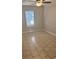A vacant bedroom includes tile floors, a ceiling fan, and a window with horizontal blinds at 1676 Citadel Ln., Myrtle Beach, SC 29577