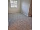Vacant bedroom with gray carpeting and a large window dressed with horizontal blinds at 1676 Citadel Ln., Myrtle Beach, SC 29577