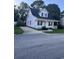 Quaint home featuring a welcoming porch, a manicured lawn and a paved driveway at 1676 Citadel Ln., Myrtle Beach, SC 29577