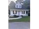 Charming home with a cozy front porch, black shutters, and a well-manicured lawn at 1676 Citadel Ln., Myrtle Beach, SC 29577