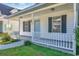 Inviting front porch with white railings, complementing the blue door and black shutters at 1676 Citadel Ln., Myrtle Beach, SC 29577