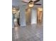 Open living area with ceiling fan, tile flooring, and a view into the updated kitchen and bathroom at 1676 Citadel Ln., Myrtle Beach, SC 29577