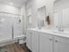 Bright bathroom features double sinks, white cabinets, and a glass-enclosed shower at 1704 Perthshire Loop, Myrtle Beach, SC 29579