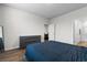 Simple bedroom featuring minimalist furniture, a queen-size bed, and hardwood floors at 1704 Perthshire Loop, Myrtle Beach, SC 29579
