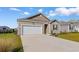 Single-story home featuring an attached garage, manicured lawn, and driveway leading up to the residence at 1704 Perthshire Loop, Myrtle Beach, SC 29579