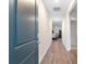 Hallway with wood flooring offers a view of a dining area and a bright doorway at 1704 Perthshire Loop, Myrtle Beach, SC 29579