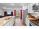 Well-lit kitchen with stainless steel appliances, granite counters, island with sink, and open floor plan at 1704 Perthshire Loop, Myrtle Beach, SC 29579