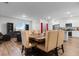 Open-concept living area with dining table and chairs flowing into the kitchen with island and stainless appliances at 1704 Perthshire Loop, Myrtle Beach, SC 29579