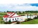 Aerial view of a red-roofed house, pool, palm trees, and waterway in the background at 1716 Cravens St., Georgetown, SC 29440