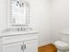 Elegant powder room featuring modern fixtures, a granite countertop, and a decorative mirror at 1716 Cravens St., Georgetown, SC 29440