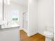 Bright bathroom featuring a marble countertop, shower with glass door and a window at 1716 Cravens St., Georgetown, SC 29440
