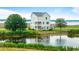 Picturesque waterfront property featuring a white two-story home nestled amidst lush greenery at 1716 Cravens St., Georgetown, SC 29440