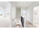 Bright hallway with staircase leading to the lower level and view of a bedroom with a ceiling fan at 1716 Cravens St., Georgetown, SC 29440