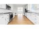 Bright kitchen features white cabinets, stainless steel appliances, and a view to the living area at 1716 Cravens St., Georgetown, SC 29440