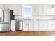 Modern kitchen featuring stainless steel appliances, white cabinetry, and granite countertops at 1716 Cravens St., Georgetown, SC 29440