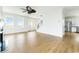 Bright living room with a fireplace, ceiling fan, staircase, and stainless steel appliances at 1716 Cravens St., Georgetown, SC 29440