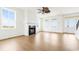 A bright living room boasts a fireplace, large windows, and light hardwood floors at 1716 Cravens St., Georgetown, SC 29440