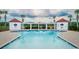 Community pool with a large pergola, bath houses, and palm trees at 1716 Cravens St., Georgetown, SC 29440