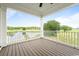 The covered porch offers a serene view of the backyard and surrounding landscape at 1716 Cravens St., Georgetown, SC 29440
