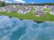 Scenic aerial shot of homes backing onto a pond with ducks swimming in the water with lush greenery and blue sky at 182 Foxford Dr., Conway, SC 29526