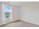 Bright bedroom with neutral carpet and white walls, filled with natural light from a large window at 182 Foxford Dr., Conway, SC 29526