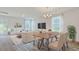 Well-lit dining area connected to living room with modern furniture and view to outside at 182 Foxford Dr., Conway, SC 29526