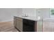 Open kitchen island featuring a stainless sink, black dishwasher and white marble countertops and wood-look flooring at 182 Foxford Dr., Conway, SC 29526