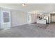 Open concept living area with plush carpeting, bright windows and view into the kitchen at 182 Foxford Dr., Conway, SC 29526
