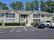 Inviting condo with a tan exterior, screened porch, and well-maintained landscaping in a desirable neighborhood at 197 Charter Dr. # D1, Longs, SC 29568
