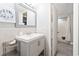 Bright bathroom with a white sink vanity, seashell decor, and a shower at 201 74Th Ave. N # 2243/2244, Myrtle Beach, SC 29572
