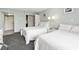 Cozy bedroom featuring two plush beds, soft lighting, and access to closet space at 201 74Th Ave. N # 2243/2244, Myrtle Beach, SC 29572