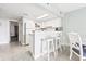 Bright kitchen featuring white cabinets, breakfast bar with stools, and modern appliances at 201 74Th Ave. N # 2243/2244, Myrtle Beach, SC 29572