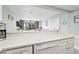 Open kitchen with a dishwasher and views of the living area and balcony at 201 74Th Ave. N # 2243/2244, Myrtle Beach, SC 29572