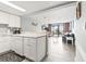 Open kitchen featuring white cabinets, stone countertops, and views of the living area at 201 74Th Ave. N # 2243/2244, Myrtle Beach, SC 29572