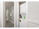 Hallway with laundry area including stacked washer and dryer and small bath at 201 74Th Ave. N # 2243/2244, Myrtle Beach, SC 29572