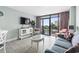 Comfortable living room featuring stylish furniture and sliding glass doors to a private balcony at 201 74Th Ave. N # 2243/2244, Myrtle Beach, SC 29572