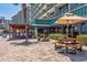 Open-air patio area with picnic tables for outdoor dining with nearby condo and palm trees at 201 74Th Ave. N # 2243/2244, Myrtle Beach, SC 29572