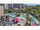 Resort-style pool area with lazy river, palm trees, and lounge chairs offers a relaxing atmosphere at 201 74Th Ave. N # 2243/2244, Myrtle Beach, SC 29572